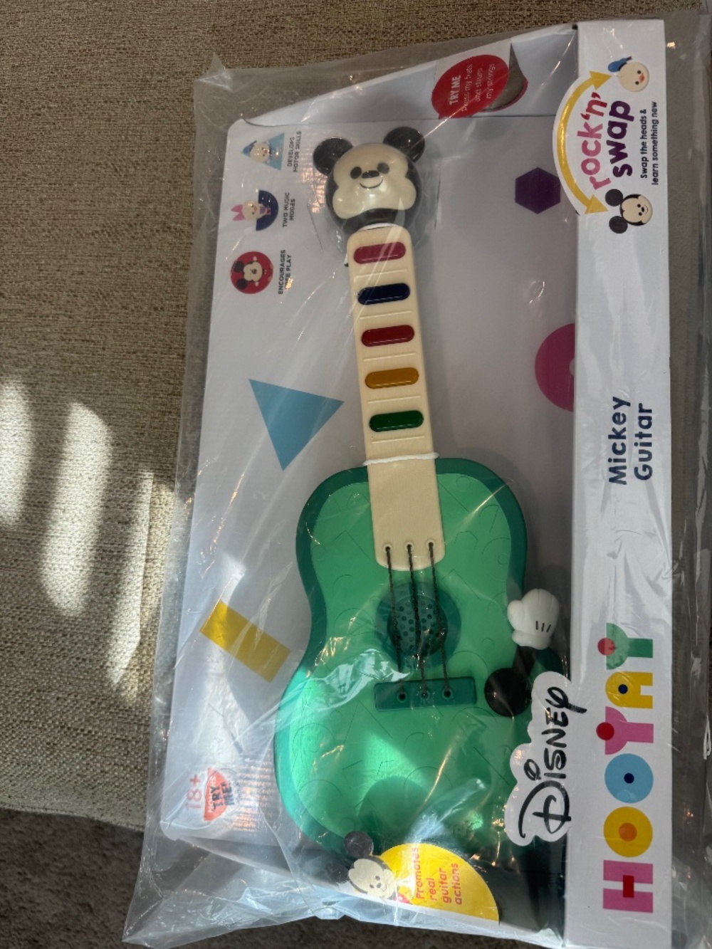 Mickey learning guitar